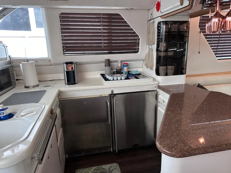 Slide: The Image of 1995 Sea Ray 550 Sedan Bridge kitchen with modern appliances and sleek countertops. - 47