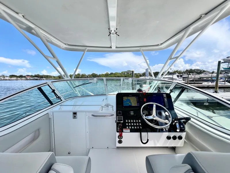 Slide: The Image of 2022 Stamas 326 Aegean boat cockpit with steering wheel and navigation controls. - 12