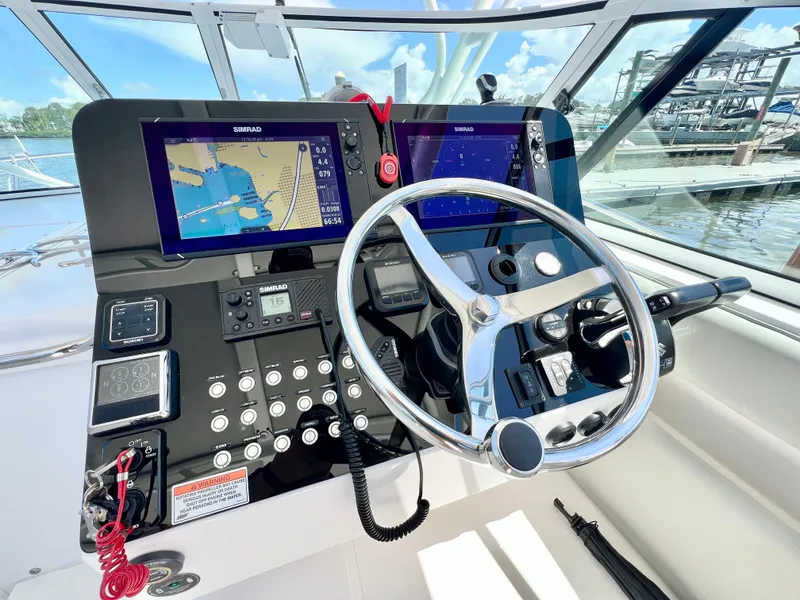 Slide: The Image of Stamas 326 Aegean 2022 helm with dual navigation screens and steering wheel. - 14