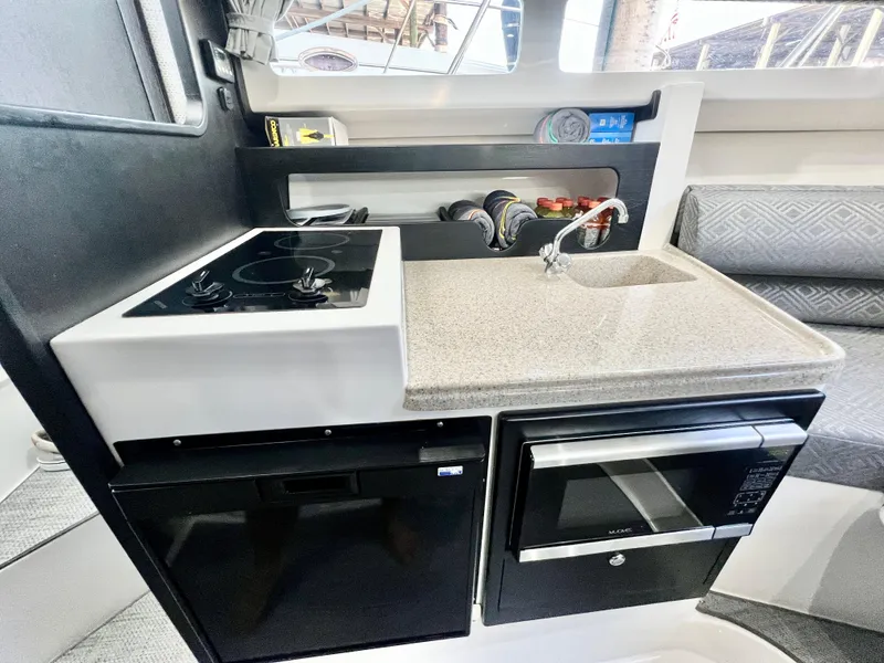 Slide: The Image of 2022 Stamas 326 Aegean boat kitchen with stove, sink, and microwave. - 22