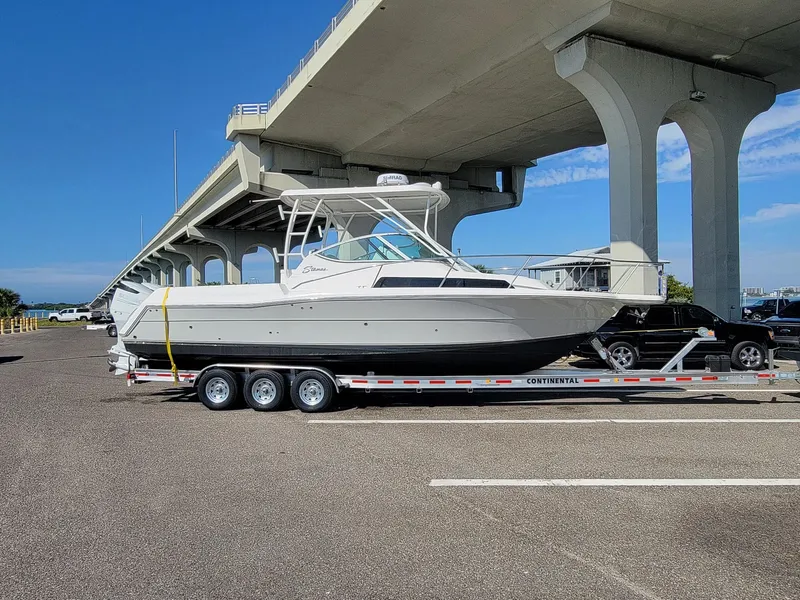 Slide: The Image of 2022 Stamas 326 Aegean boat on trailer under bridge, clear sky background. - 29