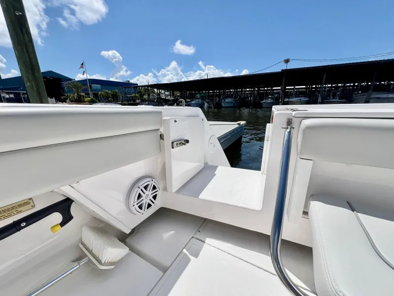 Slide: The Image of 2022 Stamas 326 Aegean boat interior, featuring sleek white seating and dockside view. - 5