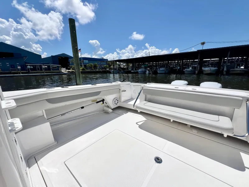 Slide: The Image of 2022 Stamas 326 Aegean boat interior at marina, featuring spacious seating and clear skies. - 6