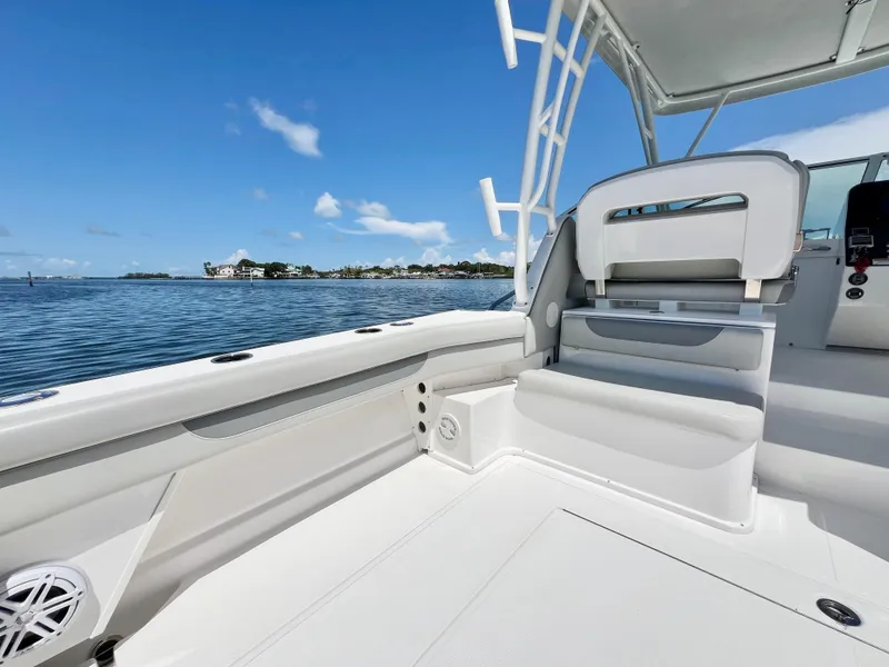 Slide: The Image of Stamas 326 Aegean 2022 boat interior with seating, ocean view, and clear blue sky. - 9