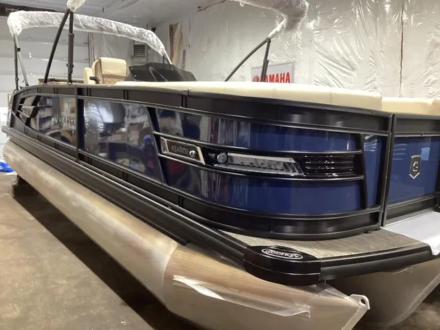 Slide: The Image of 2024 Godfrey Aqua Patio Entertainment 255 CBE pontoon boat in a showroom. - 10