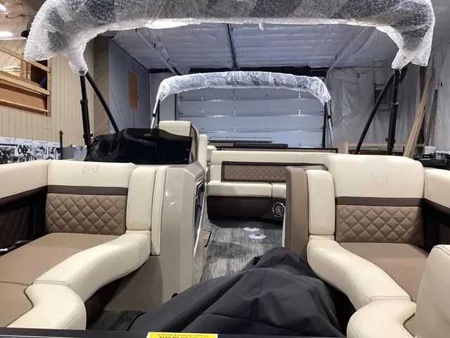 Slide: The Image of 2024 Godfrey Aqua Patio Entertainment 255 CBE pontoon boat interior with luxurious seating. - 11