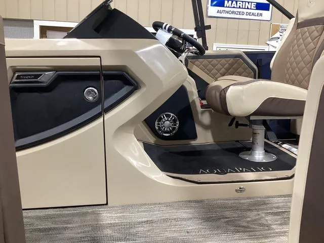 Slide: The Image of 2024 Godfrey Aqua Patio Entertainment 255 CBE interior with beige seating and modern dashboard. - 14