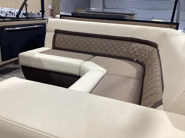 Slide: The Image of 2024 Godfrey Aqua Patio Entertainment 255 CBE interior with beige and brown quilted seating. - 15