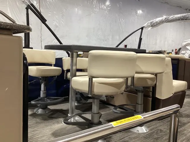 Slide: The Image of 2024 Godfrey Aqua Patio Entertainment 255 CBE interior with plush seating and table. - 17