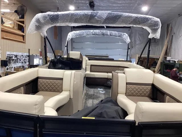 Slide: The Image of 2024 Godfrey Aqua Patio Entertainment 255 CBE pontoon boat interior with luxurious seating. - 18