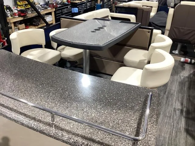 Slide: The Image of 2024 Godfrey Aqua Patio Entertainment 255 CBE interior with modern seating and table setup. - 19