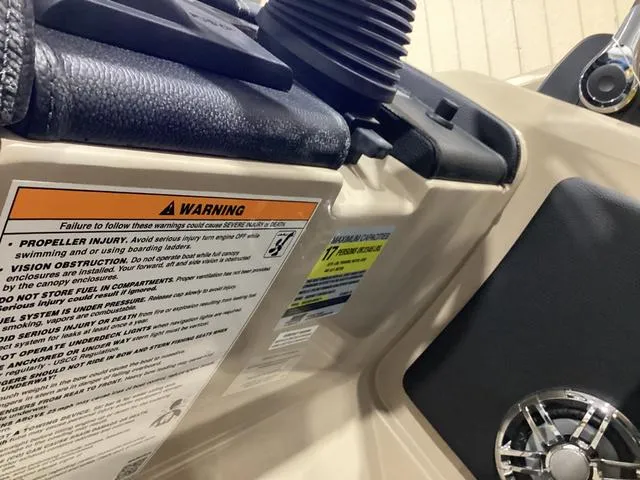 Slide: The Image of Close-up of 2024 Godfrey Aqua Patio Entertainment 255 CBE with warning labels and speaker. - 22