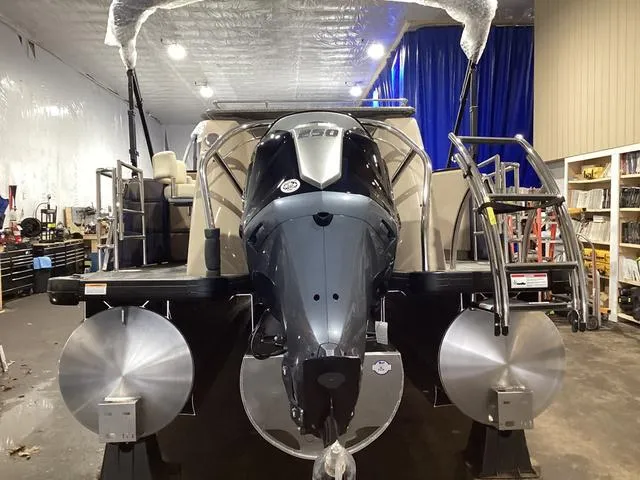 Slide: The Image of 2024 Godfrey Aqua Patio Entertainment 255 CBE pontoon boat in a workshop setting. - 3