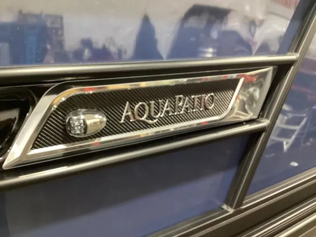 Slide: The Image of 2024 Godfrey Aqua Patio Entertainment 255 CBE nameplate on sleek blue exterior. - 8