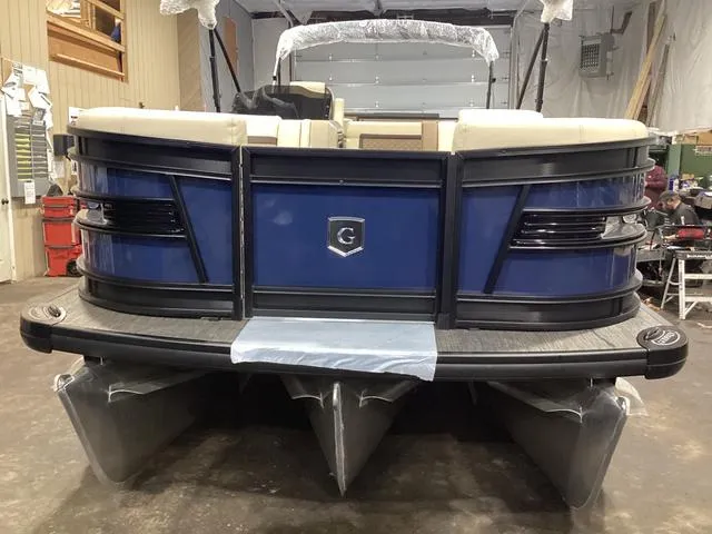 Slide: The Image of 2024 Godfrey Aqua Patio Entertainment 255 CBE pontoon boat in a showroom. - 9