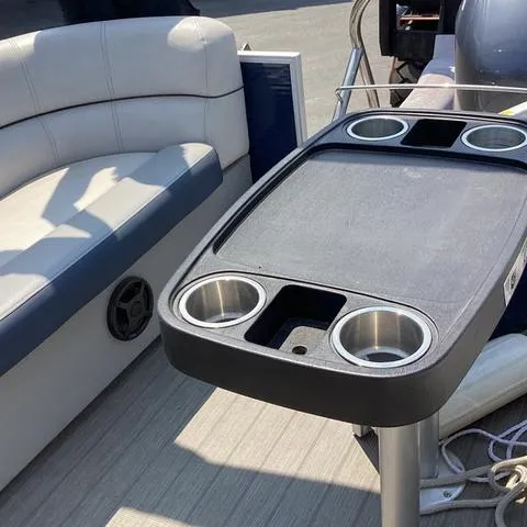 Slide: The Image of 2019 Godfrey Sw2286SB boat interior with cup holders and seating. - 10