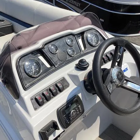 Slide: The Image of 2019 Godfrey Sw2286SB boat dashboard with steering wheel and control panel. - 6
