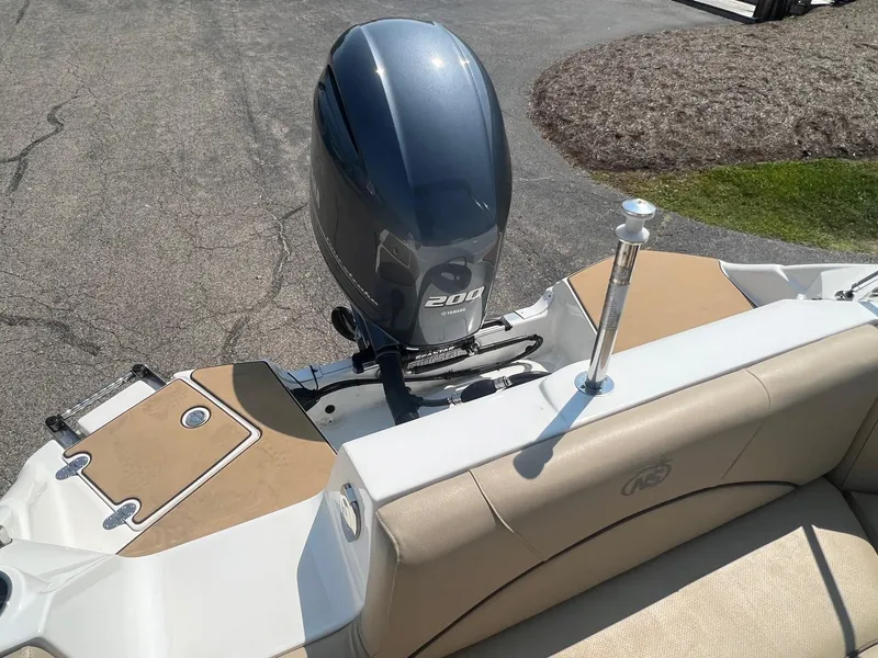 Slide: The Image of 2020 NauticStar 223 DC boat with 200 HP outboard motor, beige seating. - 10