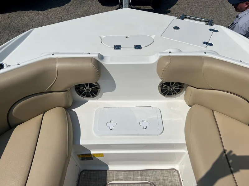 Slide: The Image of 2020 NauticStar 223 DC boat interior with beige seating and speakers. - 3
