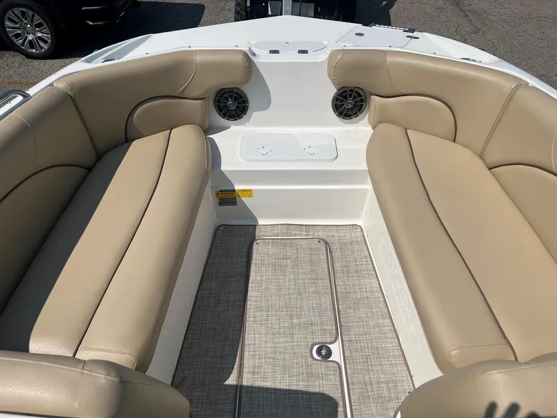 Slide: The Image of 2020 NauticStar 223 DC boat interior with beige seating and speakers. - 4