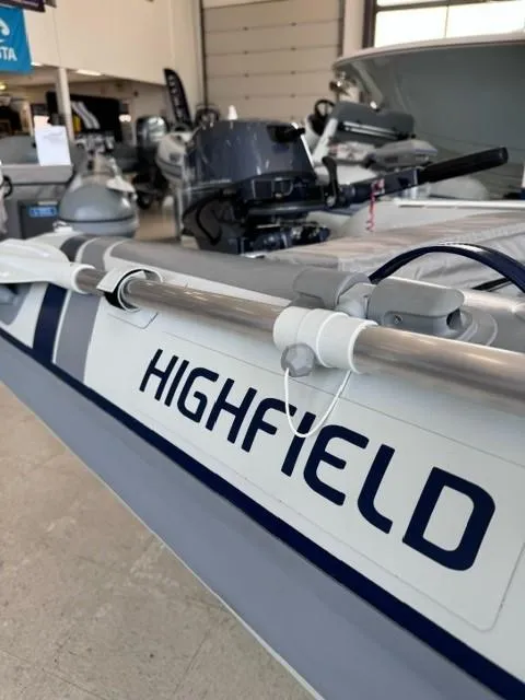 Slide: The Image of 2024 Highfield Classic 310 boat displayed in showroom. - 2