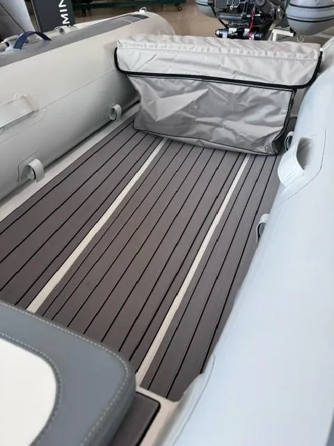 Slide: The Image of 2024 Highfield Classic 310 inflatable boat interior with gray flooring and storage bag. - 6