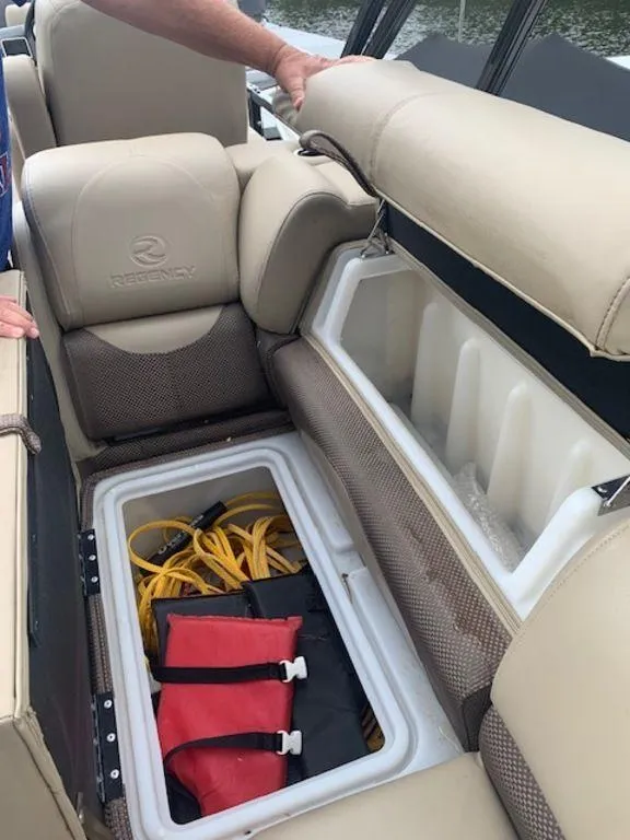 Slide: The Image of 2020 Regency 230 DL3 boat seat storage with safety gear and equipment. - 24