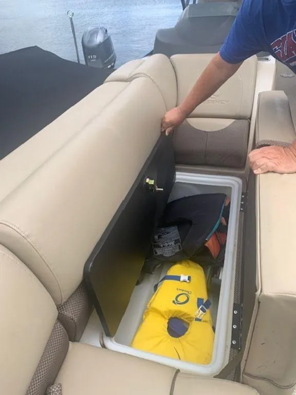 Slide: The Image of 2020 Regency 230 DL3 boat storage compartment with life jackets and gear. - 31