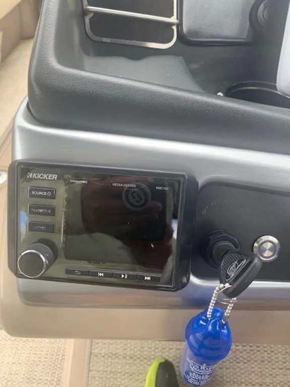 Slide: The Image of 2020 Regency 230 DL3 boat dashboard with Kicker stereo system and ignition keys. - 38