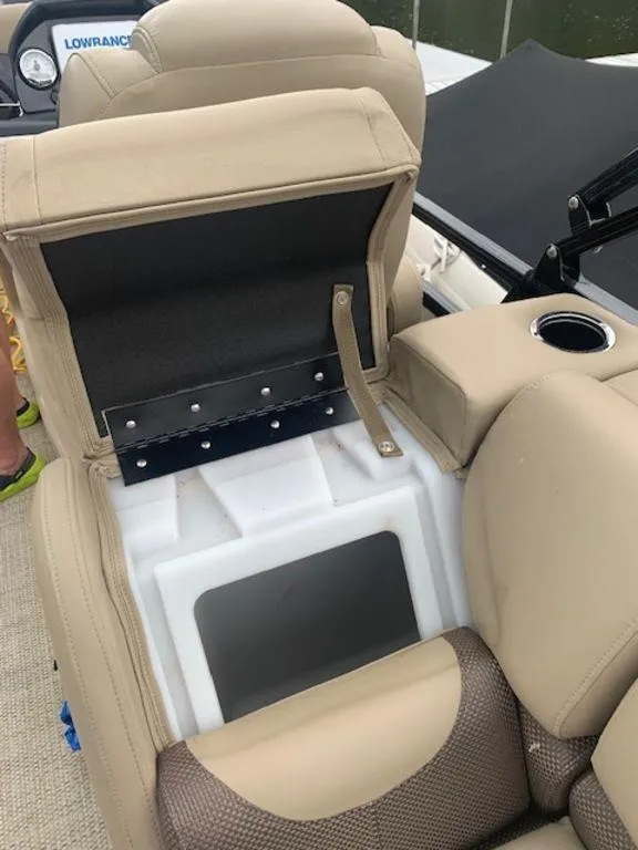 Slide: The Image of 2020 Regency 230 DL3 boat seat storage compartment with beige upholstery. - 40