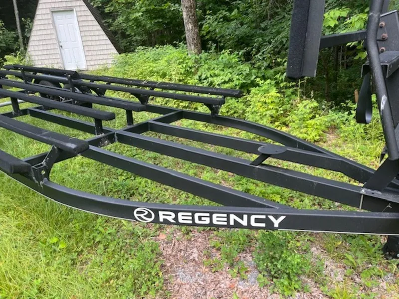 Slide: The Image of Regency 230 DL3 trailer frame, 2020 model, in a wooded area. - 45