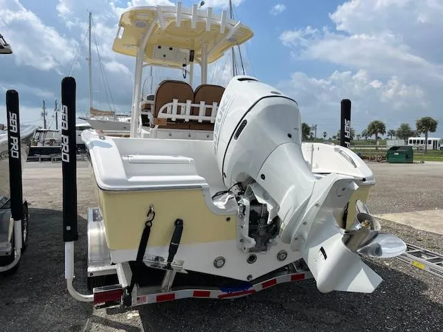 Slide: The Image of 2025 Sea Pro 222 DLX boat with powerful outboard motor, docked under a sunny sky. - 3