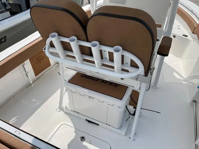Slide: The Image of 2025 Sea Pro 222 DLX boat interior with seating and rod holders. - 4