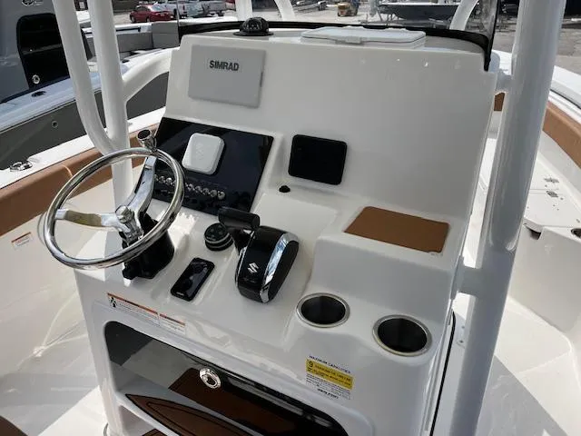 Slide: The Image of 2025 Sea Pro 222 DLX boat console with steering wheel and controls. - 5