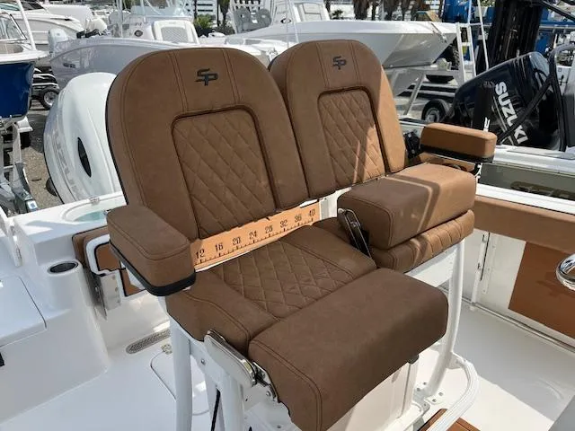 Slide: The Image of 2025 Sea Pro 222 DLX boat seats with brown upholstery and armrests. - 6