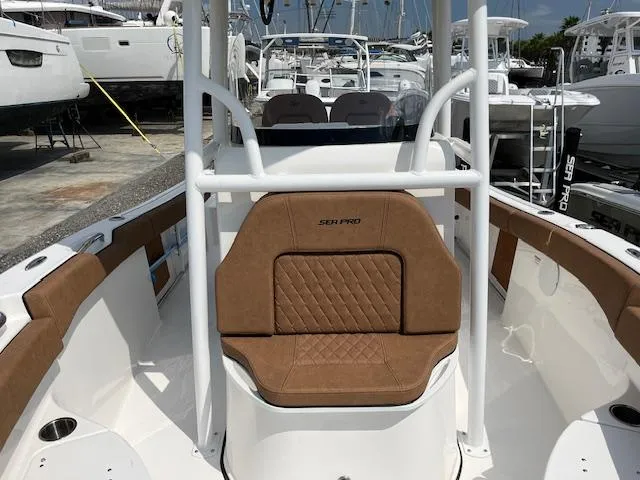 Slide: The Image of 2025 Sea Pro 222 DLX boat interior with tan seating and white frame. - 7