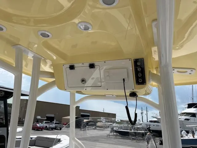 Slide: The Image of 2025 Sea Pro 222 DLX boat interior, featuring yellow overhead console and marine equipment. - 8