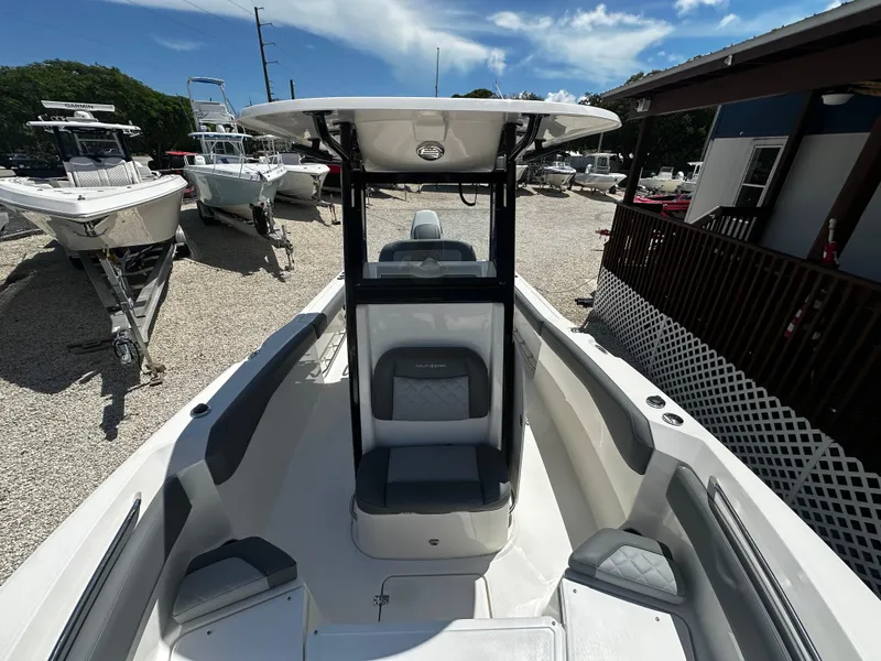 Slide: The Image of 2024 NauticStar 242 OSL boat, sleek design, spacious seating, outdoor display. - 10