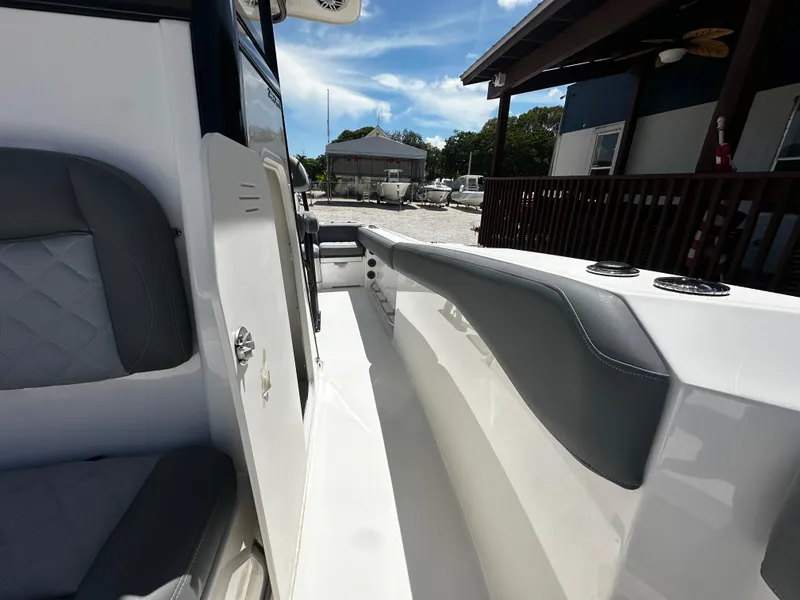 Slide: The Image of 2024 NauticStar 242 OSL boat interior with sleek seating and modern design. - 11