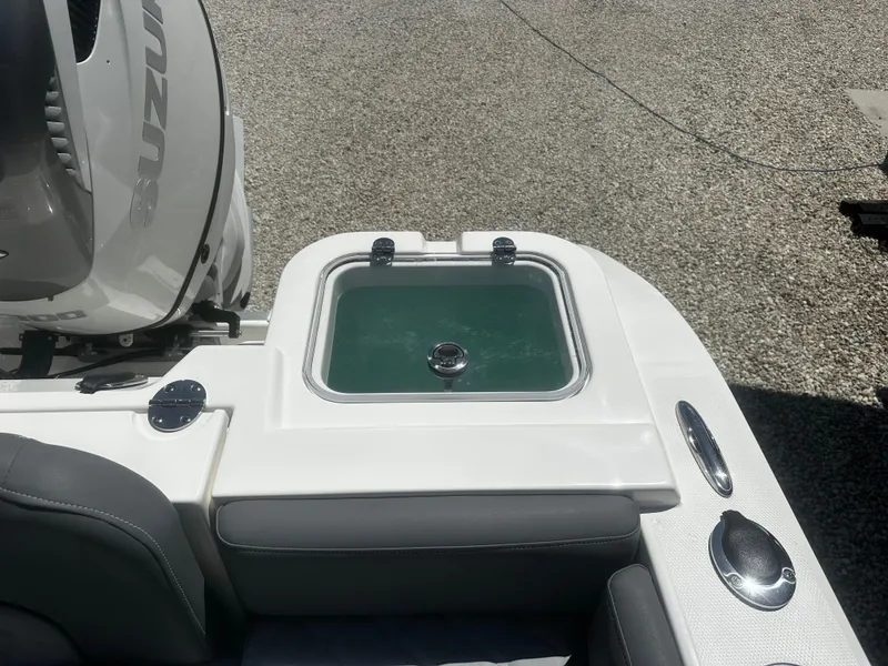 Slide: The Image of 2024 NauticStar 242 OSL boat with Suzuki engine, featuring a livewell. - 15