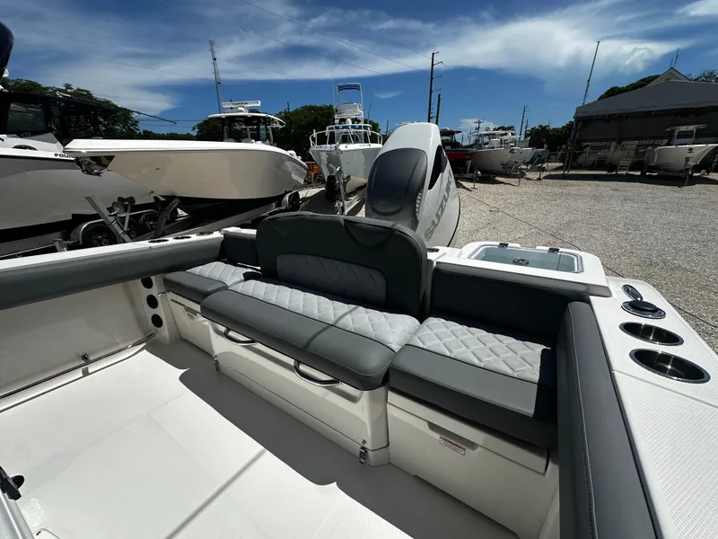 Slide: The Image of 2024 NauticStar 242 OSL boat interior with seating and cup holders. - 5