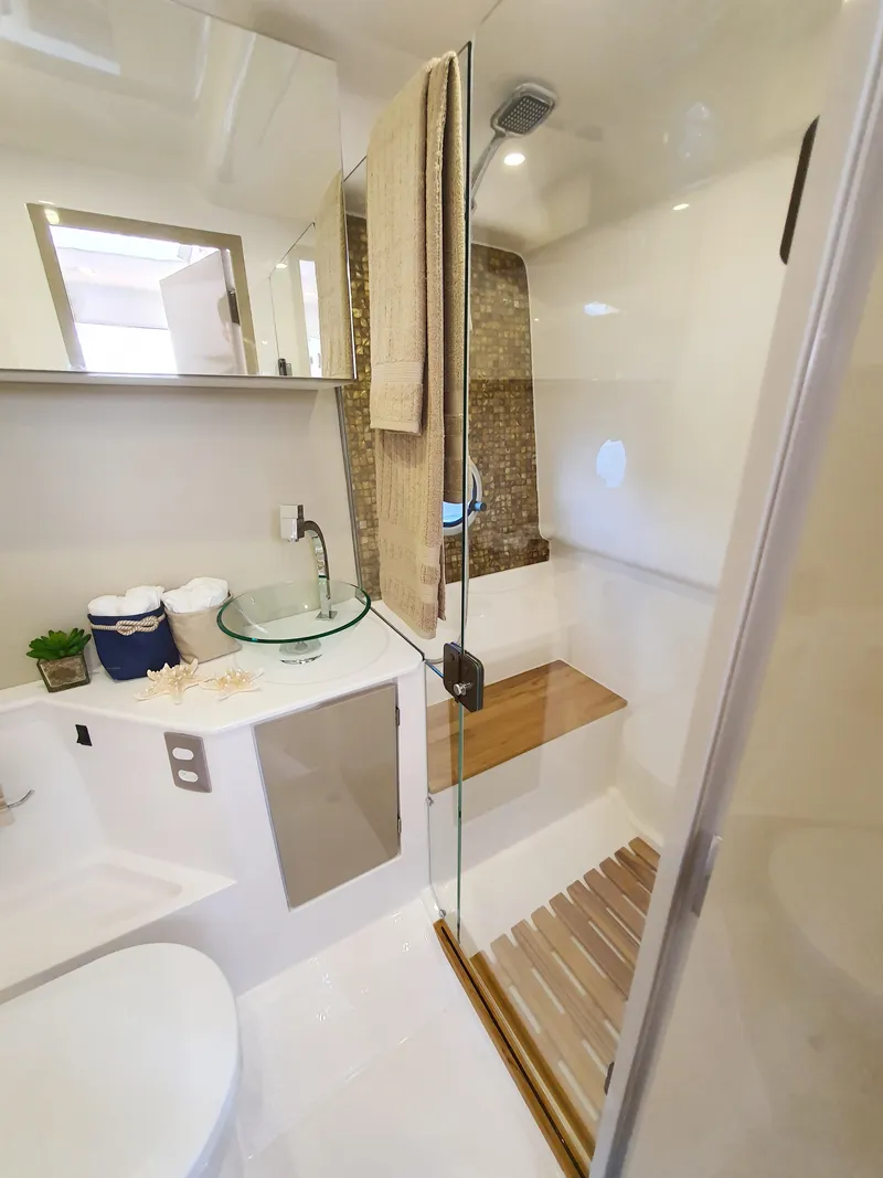 Slide: The Image of Modern bathroom in 2025 Hanover 387 model with glass shower and wooden accents. - 5