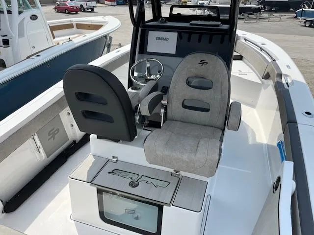 Slide: The Image of 2025 Sea Pro 245 FLX boat interior with dual seats and steering console. - 13