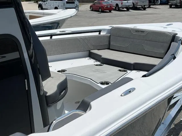 Slide: The Image of 2025 Sea Pro 245 FLX boat interior with cushioned seating and cup holders. - 16