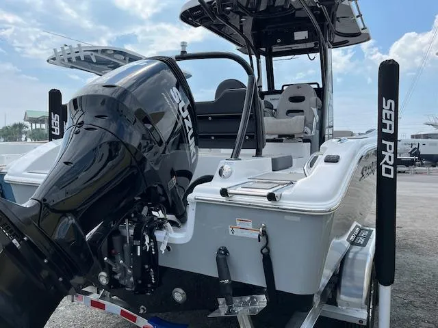 Slide: The Image of 2025 Sea Pro 245 FLX boat with Suzuki outboard motor, docked outdoors. - 4