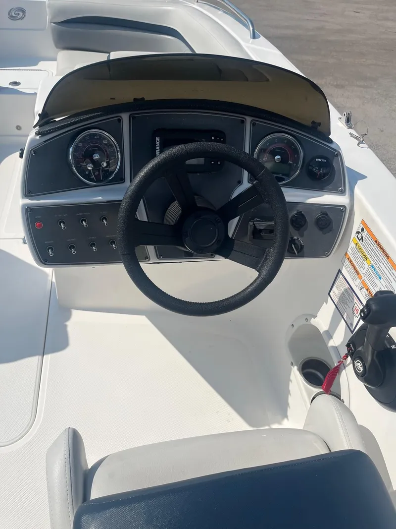 Slide: The Image of 2021 Hurricane SunDeck Sport 192 RL OB boat dashboard with steering wheel and controls. - 5