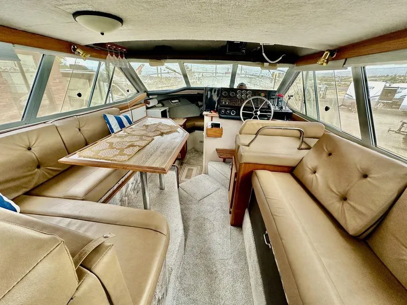 Slide: The Image of Interior of 1986 Bayliner 2850 Command Bridge with tan seating and steering console. - 13