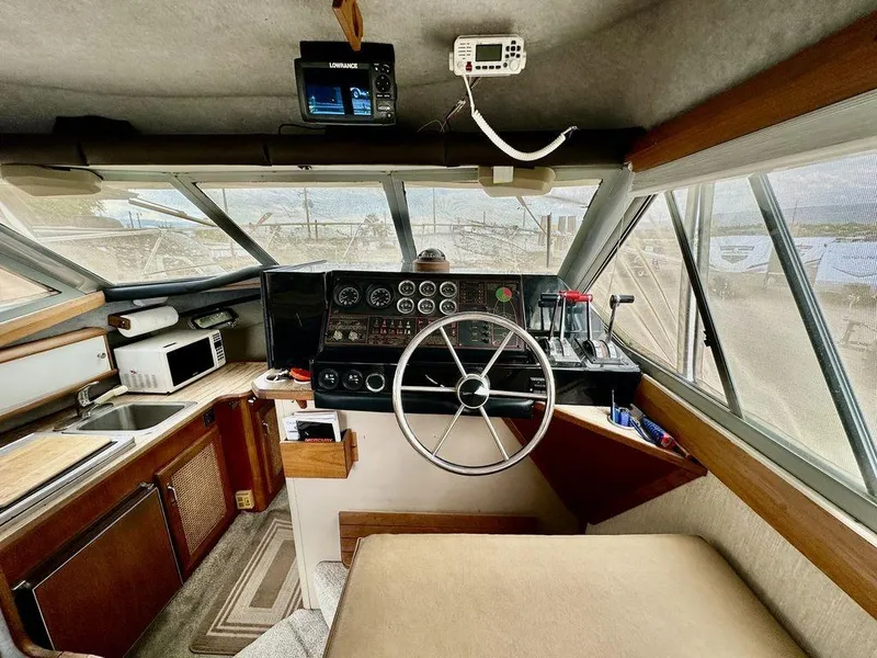 Slide: The Image of Interior of 1986 Bayliner 2850 Command Bridge with steering wheel and control panel. - 14