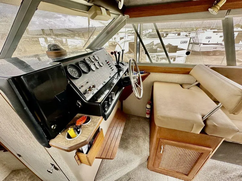 Slide: The Image of 1986 Bayliner 2850 Command Bridge interior with helm, steering wheel, and seating area. - 15