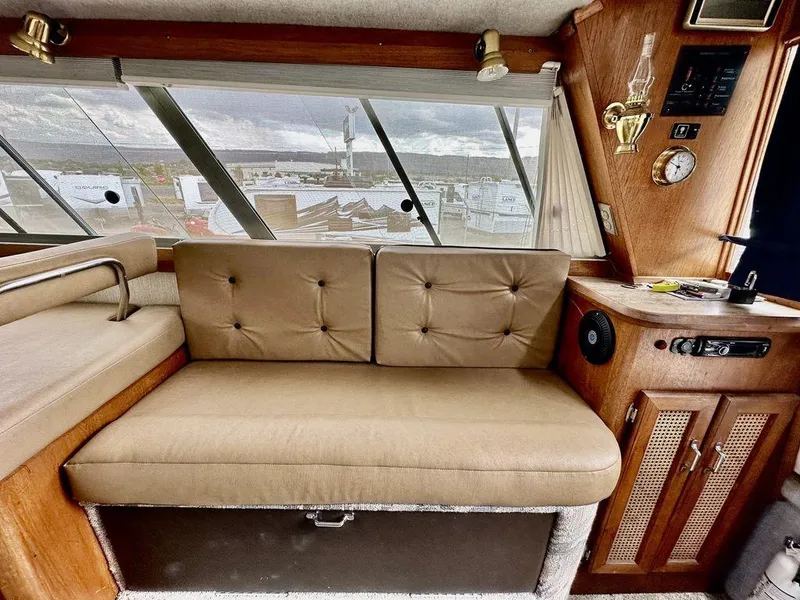 Slide: The Image of Interior of 1986 Bayliner 2850 Command Bridge with tan seating and wood accents. - 16